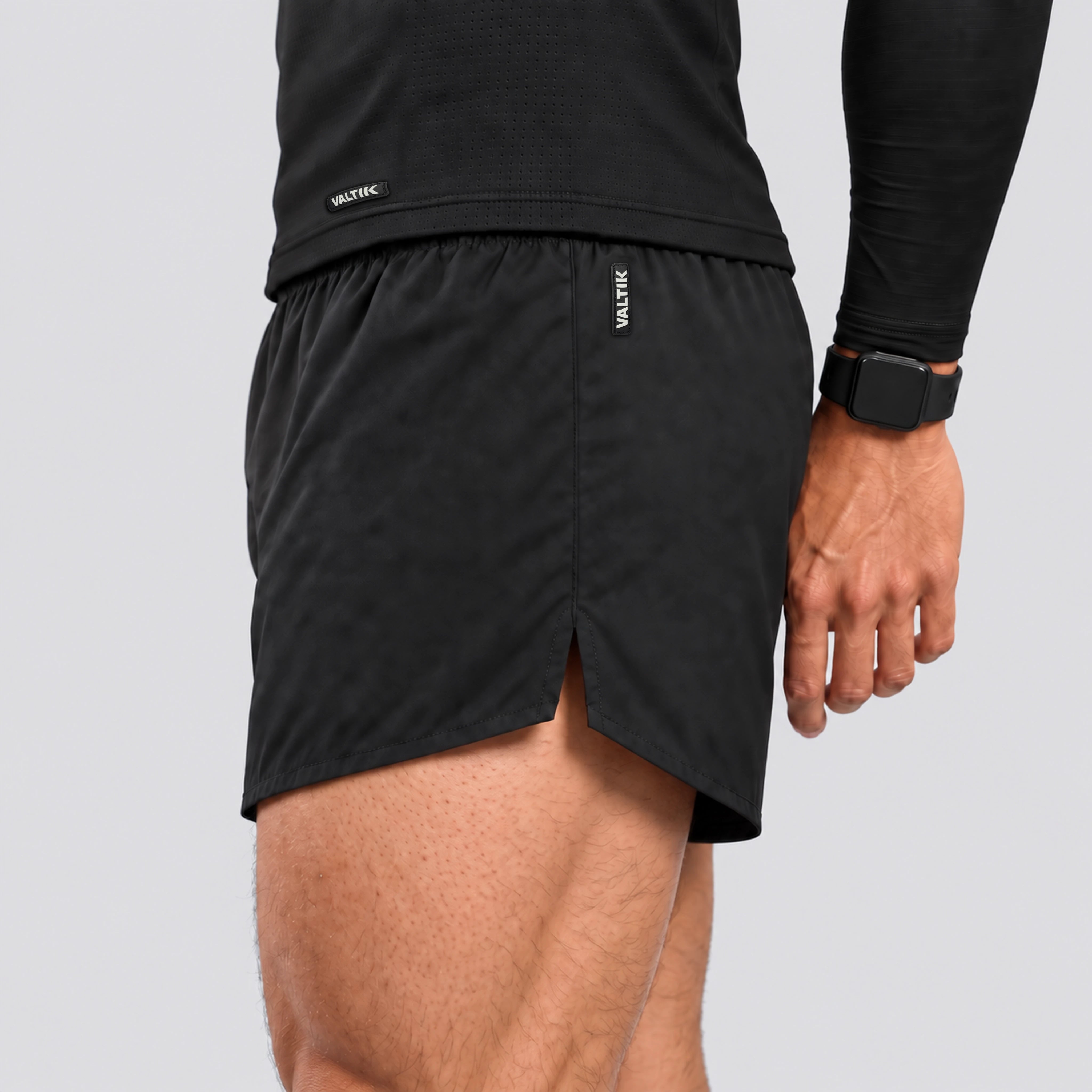 Short deportivo STRIDE de VALTIK para hombre en color negro, detalle lateral de la abertura, costuras y etiqueta.